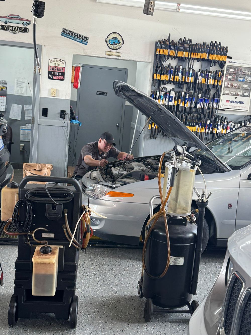 Finish Line technician working under the hood of a vehicle